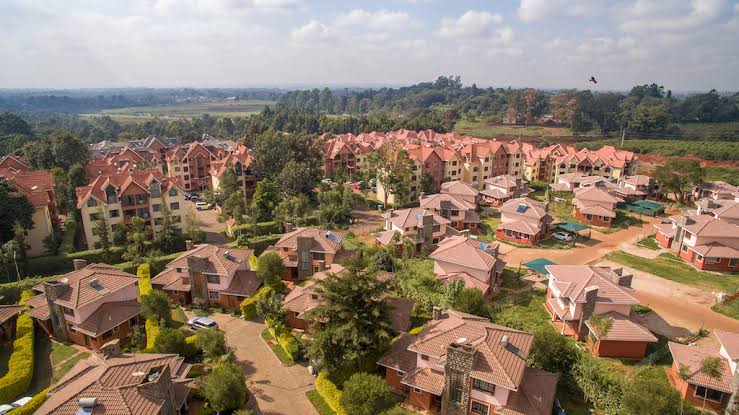 Aerial view of modern single-family villas and apartment blocks in Fourways Junction Estate along Kiambu Road, Nairobi, showcasing a premier secure gated community development.