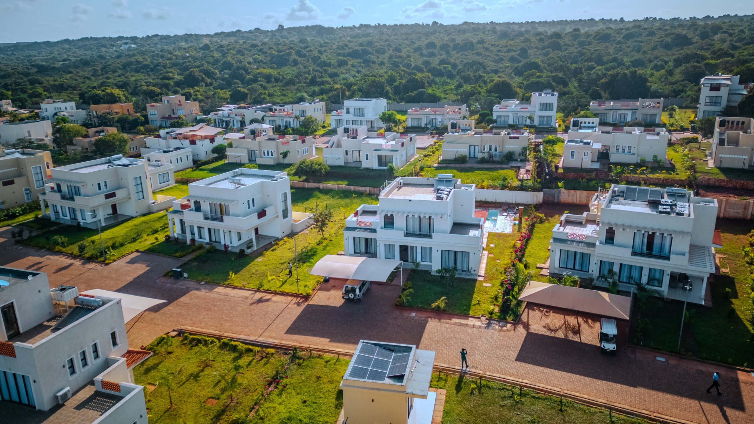 Aerial view of luxury white villas and holiday homes at Pazuri at Vipingo in Kilifi, Kenya, showcasing contemporary gated community housing developments for real estate acquisition.
