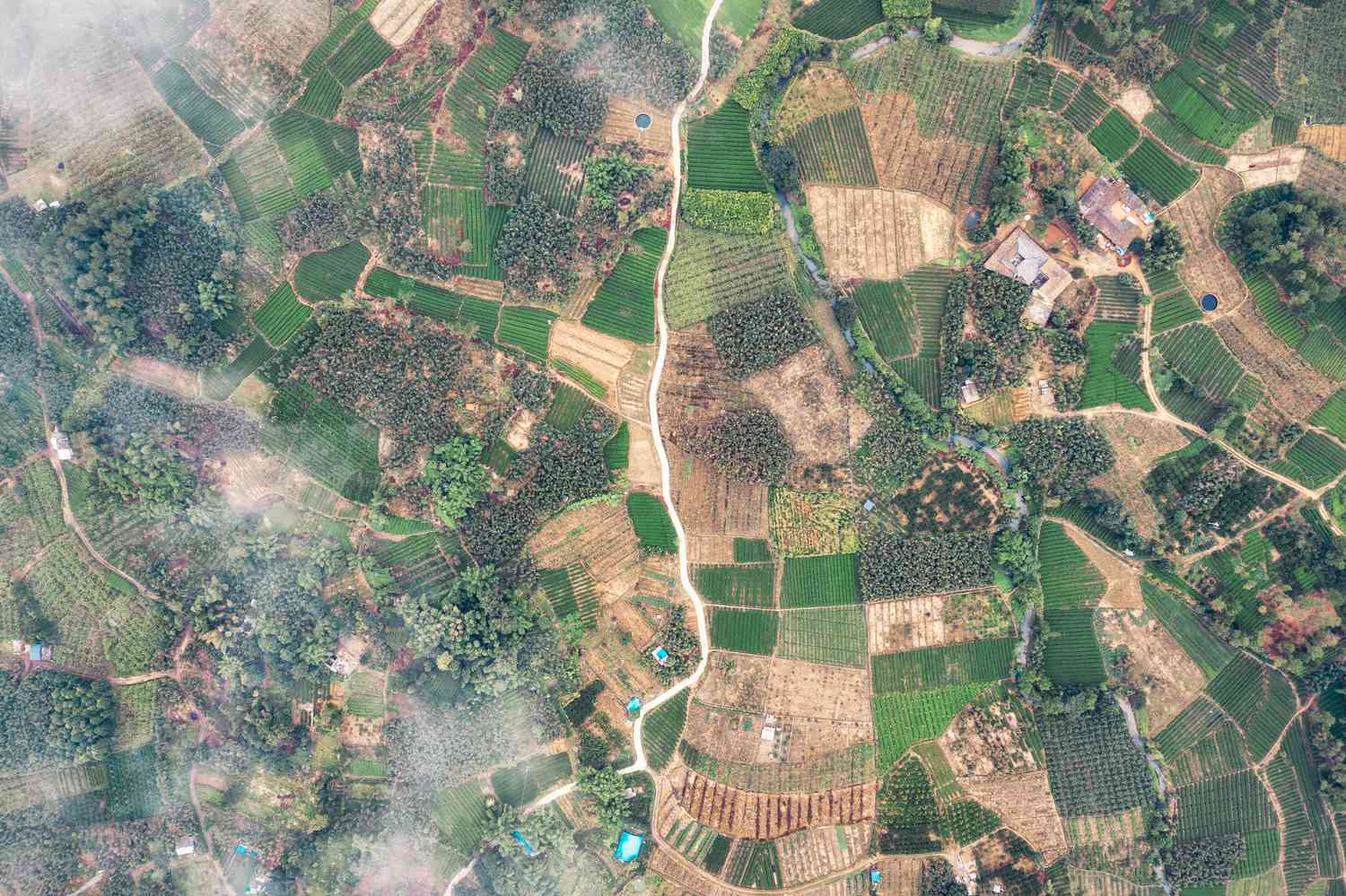 High-altitude aerial view of subdivided agricultural plots and farmland mosaic, showcasing rural real estate infrastructure, land banking opportunities, and strategic acreage for acquisition.
