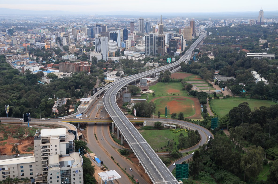 Aerial view of the Nairobi Expressway passing through the city center, highlighting modern transit infrastructure that boosts surrounding commercial property values and land acquisition.